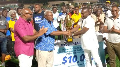 Ambassador Amarkai Amarteifio (left) presenting the winners trophy to Godwin Attram (right) while Dr Daniel McKorley (sponsor of the event, left) looks on. Oly oldies beat Hearts 2-0