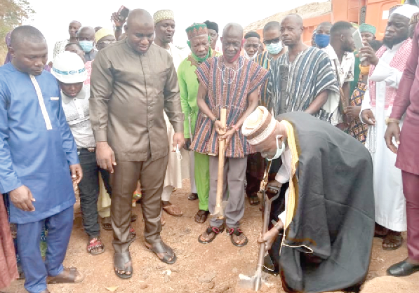  • Chief Mohammed Bala Shaibu cutting the sod as Mr Mashud Mohammed (left), Mr Gibrine Issah Tutu (2nd left), and Nana Kwakye Agyakwa (3rd left) look on