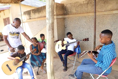 Pastor Acheampong (standing left), supervising the pupils during one of their music sessions. Pastor Acheampong (standing left), supervising the pupils during one of their music sessions.