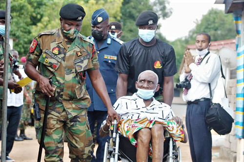 Prince Amartey (in wheelchair) being accompanied to the inauguration ceremony by an army officer Prince Amartey (in wheelchair) being accompanied to the inauguration ceremony by an army officer