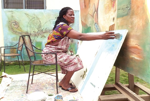 Ms Glory painting on a canvas