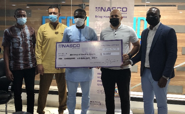 Mr Nour Sekloui (2nd right) presenting a dummy cheque to Mr Mustapha Ussif, Minister of Youth and Sports Mr Nour Sekloui (2nd right) presenting a dummy cheque to Mr Mustapha Ussif, Minister of Youth and Sports