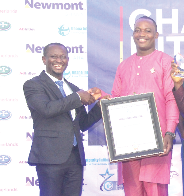 Mr Alfred Tuah-Yeboah (left), Deputy Attorney-General and Deputy Minister of Justice, presenting a citation to Mr Confidence Fiagadzi, a Detective Lance Corporal, Kaneshie Police Station, for winning  the Personality of the Year award. Picture: BENEDICT OBUOBI