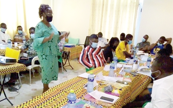 Ms Rebecca Onyame (standing), the lead facilitator, taking the participants through the training Ms Rebecca Onyame (standing), the lead facilitator, taking the participants through the training