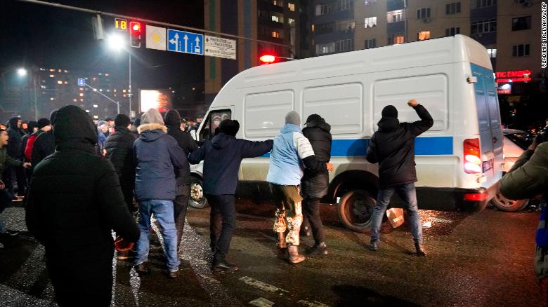 Demonstrators try to block a police bus during a protest in Almaty, Kazakhstan on January 4, 2022. Demonstrators try to block a police bus during a protest in Almaty, Kazakhstan on January 4, 2022.
