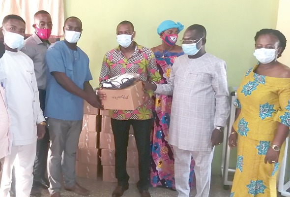 Dr Kingsley Nyarko (middle) presenting nose masks and sanitisers to Mr Samuel Gyasi, the Presiding Member for distribution to the residents of his electoral area Dr Kingsley Nyarko (middle) presenting nose masks and sanitisers to Mr Samuel Gyasi, the Presiding Member for distribution to the residents of his electoral area