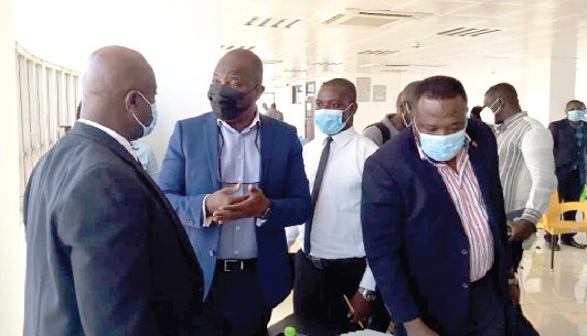 Mr. Roderick Daddy-Adjei (left) interacting with Mr. Johnny Mante (middle), Vice-Chairman and Head of the Technical Committee of GIFF, and other participants after the forum