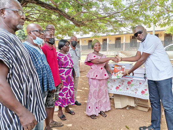 • Mr Bright Atiase (right), President of DEPOSA, handing over the books to Mrs Vivian Agbesi Amenya, head teacher of the Peki Dzake E. P school • Mr Bright Atiase (right), President of DEPOSA, handing over the books to Mrs Vivian Agbesi Amenya, head teacher of the Peki Dzake E. P school