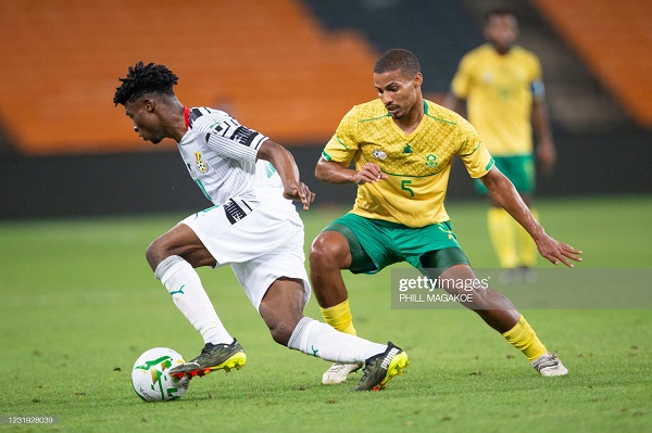 Ghana midfielder Mohammed Kudus dribbles past Rivaldo Coetzee (left) in the Africa Cup of Nations qualifier at the FNB stadium in Johannesburg Ghana secure ninth straight AFCON qualification