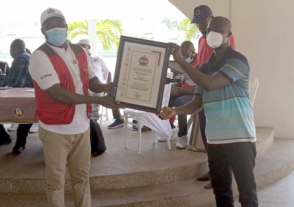 • Mr Thomas A. Atiah (left) of the ICU receiving a certificate of honour from Mr Joseph Korto, Presiding Member of the Tema Metropolitan Assembly Mitigate impact of tax hikes - Cape Coast, Tema workers urge govt