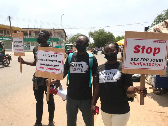 Some members of the group displaying placards with various inscriptions Some members of the group displaying placards with various inscriptions