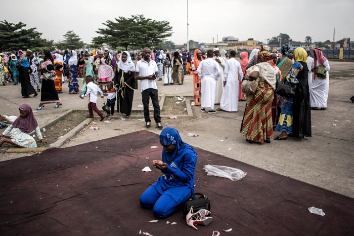 A Muslim worshipper prays to celebrate Eid al-Fitr at the Martyrs' Stadium in Kinshasa [File: John Wessels/AFP]