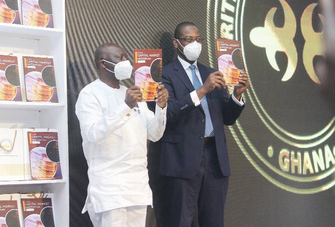 Mr Ken Ofori-Atta, Minister, Finance and Economic Planning, launching the Ghana Capital Market Master Plan Book. Aiding him is Reverend Daniel Ogbarmey Tetteh (right), Director- General, Securities and Exchange Commision, Ghana. Picture: BENEDICT OBUOBI