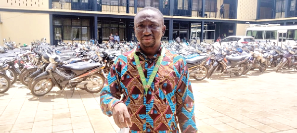 Mr Mutawakilu Abdulai, DVLA Regional Manager, speaking to the press. Behind him are some of the impounded motorbikes