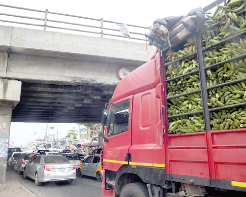An overloaded truck passing under the Abofu Bridge at Achimota in Accra. Picture: emmanuel quaye An overloaded truck passing under the Abofu Bridge at Achimota in Accra. Picture: emmanuel quaye