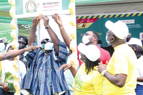 Mr Kwaku Ofori Asiamah, Minister of Transport, cutting a ribbon to launch the NRSA Stay Alive campaign in Accra. Looking on are some officials of the NRSA and other dignitaries. Picture: Patrick Dickson Mr Kwaku Ofori Asiamah, Minister of Transport, cutting a ribbon to launch the NRSA Stay Alive campaign in Accra. Looking on are some officials of the NRSA and other dignitaries. Picture: Patrick Dickson