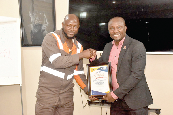 Mr Denis Amui (right) presenting a certificate to one of the participants Mr Denis Amui (right) presenting a certificate to one of the participants