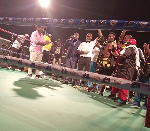 Referee Roger Barnor lifts the hand of winner Emmanuel Quaye Quaye stops Agyemang to win national title
