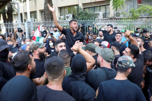 Supporters of Lebanese groups Hezbollah and Amal and the Marada movement take part in a protest against Tarek Bitar, the lead judge of the port blast investigation, near the Justice Palace in Beirut [Mohamed Azakir/Reuters]
