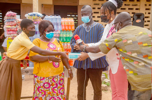 Ms Eunice Aba Sackey (2nd from right), presenting the items to Mrs Mariam Teiko, while some teachers and pupils of the school look on Ms Eunice Aba Sackey (2nd from right), presenting the items to Mrs Mariam Teiko, while some teachers and pupils of the school look on