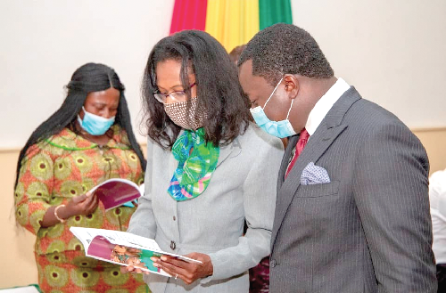 Rev Ntim Fordjour, Deputy Minister of Education, reading a book with Rasheena Reid, Head of USAID Learning, at the launch of Transition to English (T2E) Plus Steering Committee Rev Ntim Fordjour, Deputy Minister of Education, reading a book with Rasheena Reid, Head of USAID Learning, at the launch of Transition to English (T2E) Plus Steering Committee