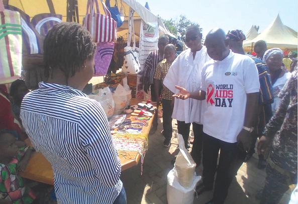 Stephen Yakubu (right), the Upper East Regional Minister, interacting with an exhibitor during a visit to the fair Stephen Yakubu (right), the Upper East Regional Minister, interacting with an exhibitor during a visit to the fair