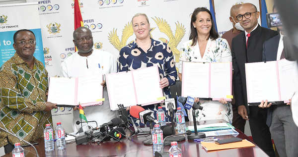  Ken Ofori Atta (2nd from left), Minister of Finance, with Dr Owusu Afriyie Akoto (left), Minister of Agriculture, and Jutta Urpilainen (3rd from left), EU Commissioner for International Partnerships, displaying their documents after the signing. With them are Anne Sophie Ave (2nd from right), French Ambassador to Ghana, and Christoff Cotte (right), a representative of AFD. Picture: EBOW HANSON   