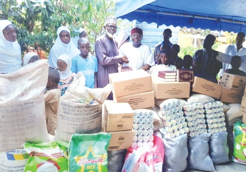 Sheikh Abubakar Yakubu Batalima (left), presenting the items to Mallam Baba on behalf of some beneficiaries