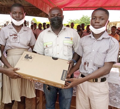 Kwabena Kwaakye (middle), Unit Manager, Land Access and Social Investment of Asanko Gold Ghana Limited, presenting the laptop to students of Kumpese for winning the JHS contest Kwabena Kwaakye (middle), Unit Manager, Land Access and Social Investment of Asanko Gold Ghana Limited, presenting the laptop to students of Kumpese for winning the JHS contest