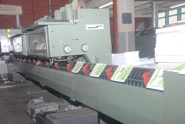 Locally printed textbooks on a production line Locally printed textbooks on a production line