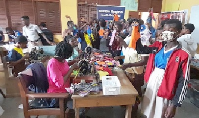 Some of the students displaying the sewn reusable menstrual pads while watching the tailors at work Some of the students displaying the sewn reusable menstrual pads while watching the tailors at work