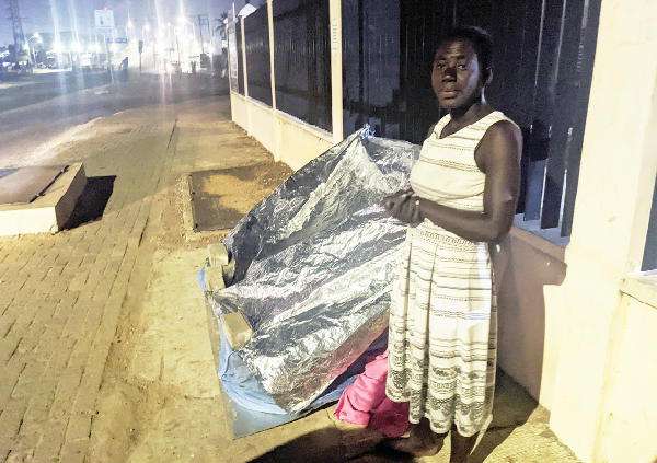 Maame Akua covering the mosquito net with plastic sheets. Pictures:Efia Akese Maame Akua covering the mosquito net with plastic sheets. Pictures:Efia Akese