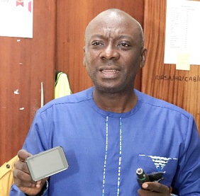 David Osafo Adonteng, acting Chief Executive Officer of NRSA, displaying the camera
