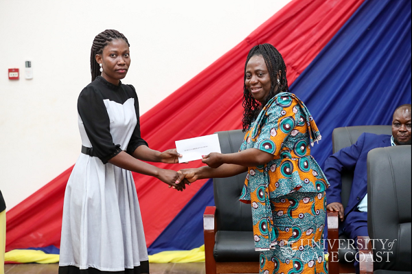 Prof Sarah Darkwa presenting one of the awardees with her research grant Prof Sarah Darkwa presenting one of the awardees with her research grant
