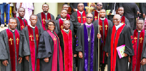 Rt. Rev. Dr Dogbe, Presiding Bishop of the Western West Africa Episcopal District of the AME Zion Church (holding a staff) with other members of the clergy Rt. Rev. Dr Dogbe, Presiding Bishop of the Western West Africa Episcopal District of the AME Zion Church (holding a staff) with other members of the clergy