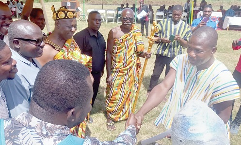 Ebenezer Papa Hottor (right), the Overall Best Farmer for the district, receiving his prize at the function