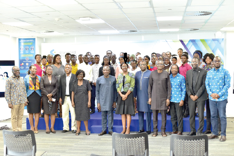 Mansa Nettey (arrowed), Chief Executive Officer (CEO) with some officials of the bank and beneficiaries of the Stanchart Endowment Fund StanChart disburses grants to 31 students