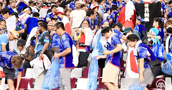 Some Japanese football fans cleaning the stadium after a match at the 2022 FIFA World Cup Some Japanese football fans cleaning the stadium after a match at the 2022 FIFA World Cup