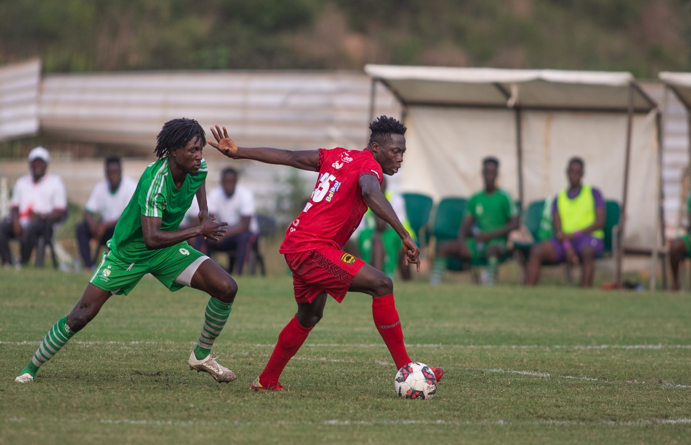 Kotoko's Justice Blay shields the ball away from an Elmina Sharks player Sharks devour Kotoko at Elmina