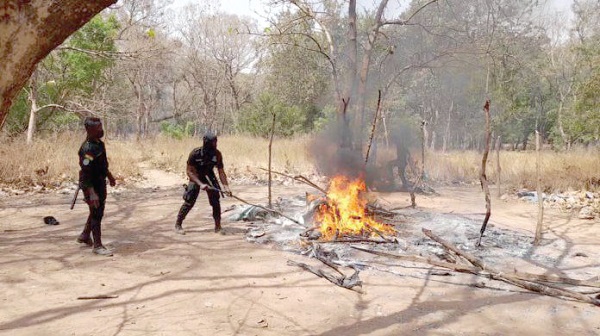 Police personnel destroying the hideout of the suspected criminals Police personnel destroying the hideout of the suspected criminals
