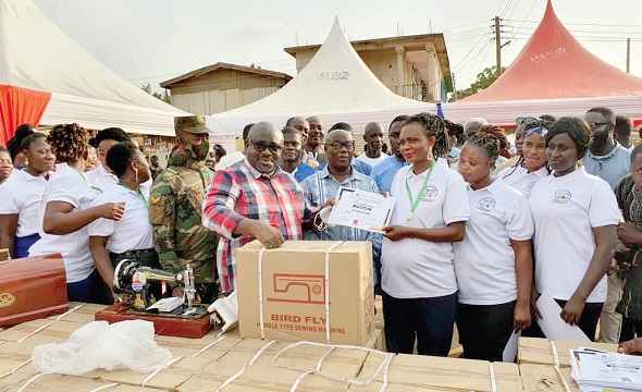 Mr Kofi Amankwah-Manu, Deputy Minister of Defence, presenting a sponsorship package to one of the beneficiaries Mr Kofi Amankwah-Manu, Deputy Minister of Defence, presenting a sponsorship package to one of the beneficiaries