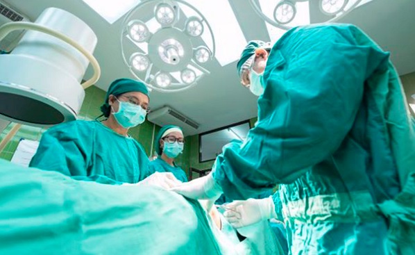 Surgeons performing a procedure on a hernia patient Surgeons performing a procedure on a hernia patient