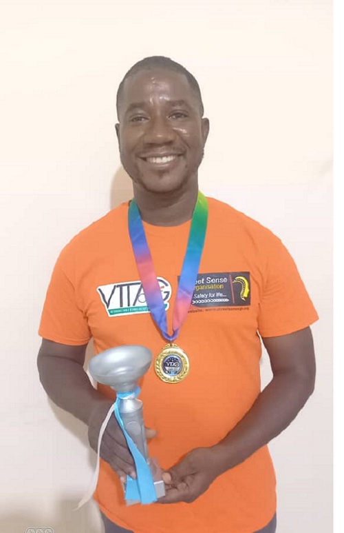 Mr Justice Ninson displaying his medal