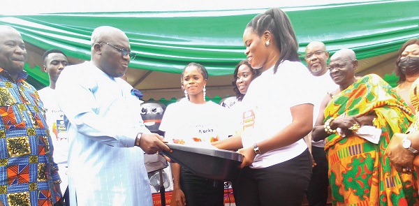 Seth Kwame Acheampong, the Eastern Regional Minister, presenting some items to one of the graduates Seth Kwame Acheampong, the Eastern Regional Minister, presenting some items to one of the graduates