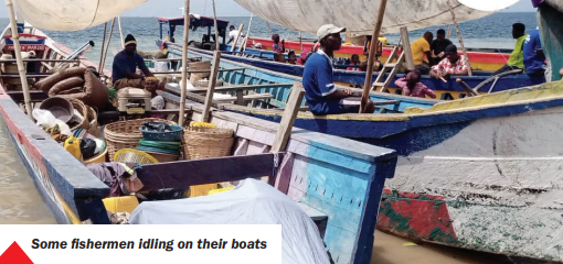 Some fishermen idling on their boats Some fishermen idling on their boats