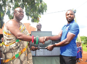 Nana Kwesi Addo II (left), Akyem Kotoku Mponua Gyasehene of Pankese, handing over the desktop computers to Charles Appiah-Kubi, the Headmaster of Pankese Roman Catholic Junior High School Nana Kwesi Addo II (left), Akyem Kotoku Mponua Gyasehene of Pankese, handing over the desktop computers to Charles Appiah-Kubi, the Headmaster of Pankese Roman Catholic Junior High School