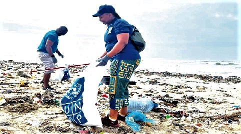 Dr Angela Lusigi (right), the Resident Representative of UNDP in Ghana, collecting plastic waste during the beach clean-up Dr Angela Lusigi (right), the Resident Representative of UNDP in Ghana, collecting plastic waste during the beach clean-up