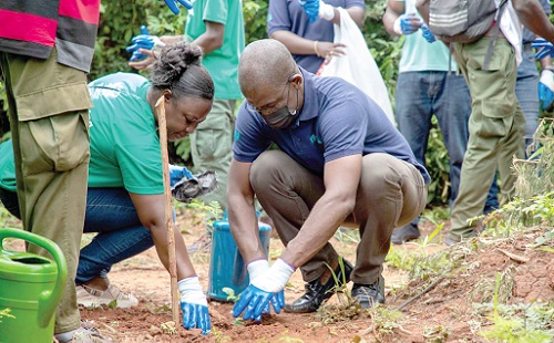 John K. Addo (right), MD, Proudential Bank, planting a tree John K. Addo (right), MD, Proudential Bank, planting a tree