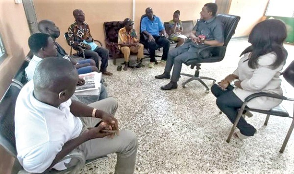 Kobby Asmah (2nd from right) engaging with Central Region-base vendors of the Graphic brand