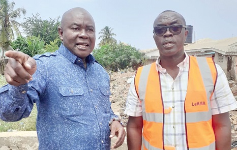 The reporter (left) being briefed by Mordecai Quarshie, Chief Executive Officer of the municipality